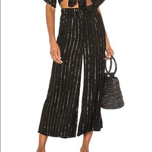 Black crop pants with gold stripes